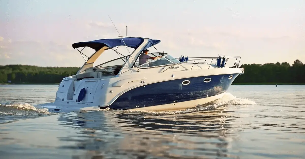 Person operating a blue and white boat on a calm body of water