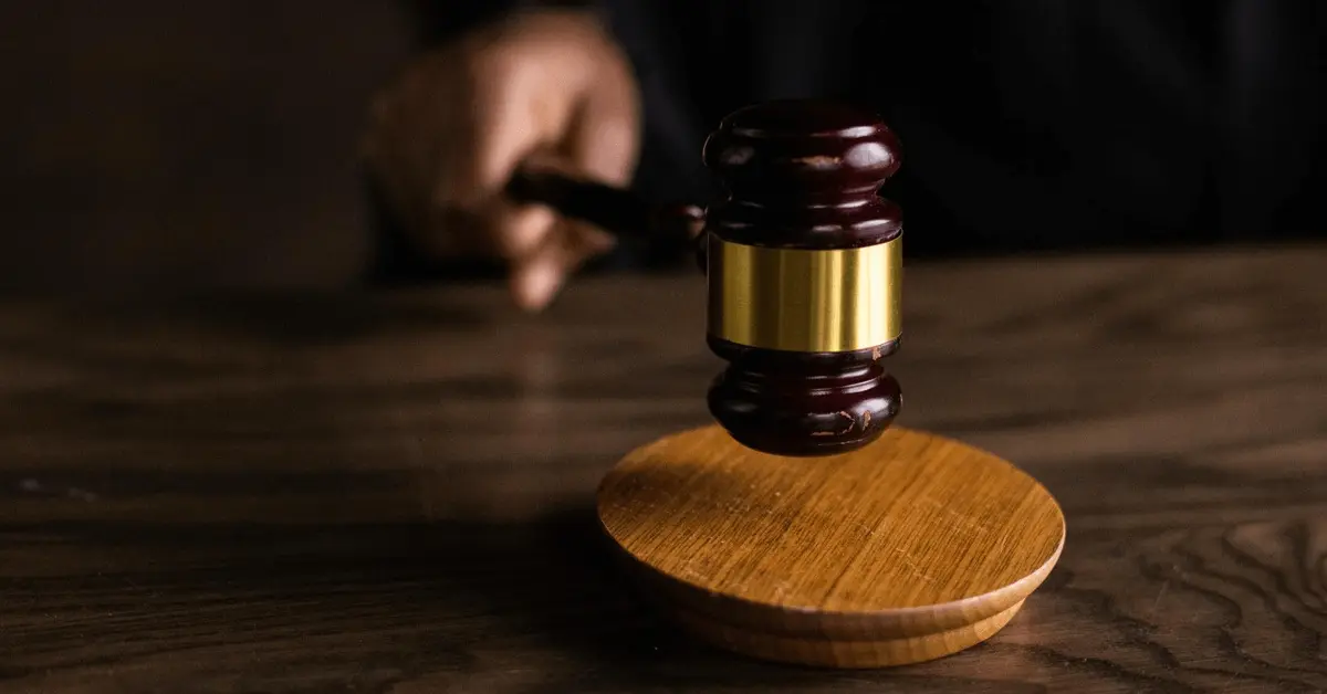 Close-up of a judge's gavel being struck on a wooden block, symbolizing the legal consequences of a DUI conviction