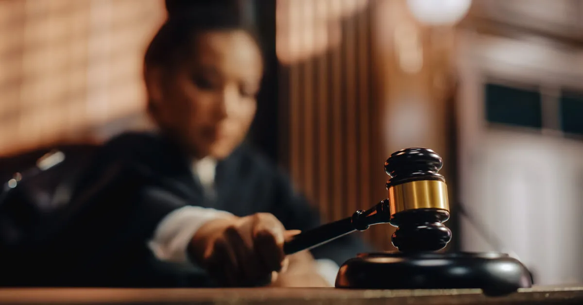 A judge striking a gavel in a courtroom