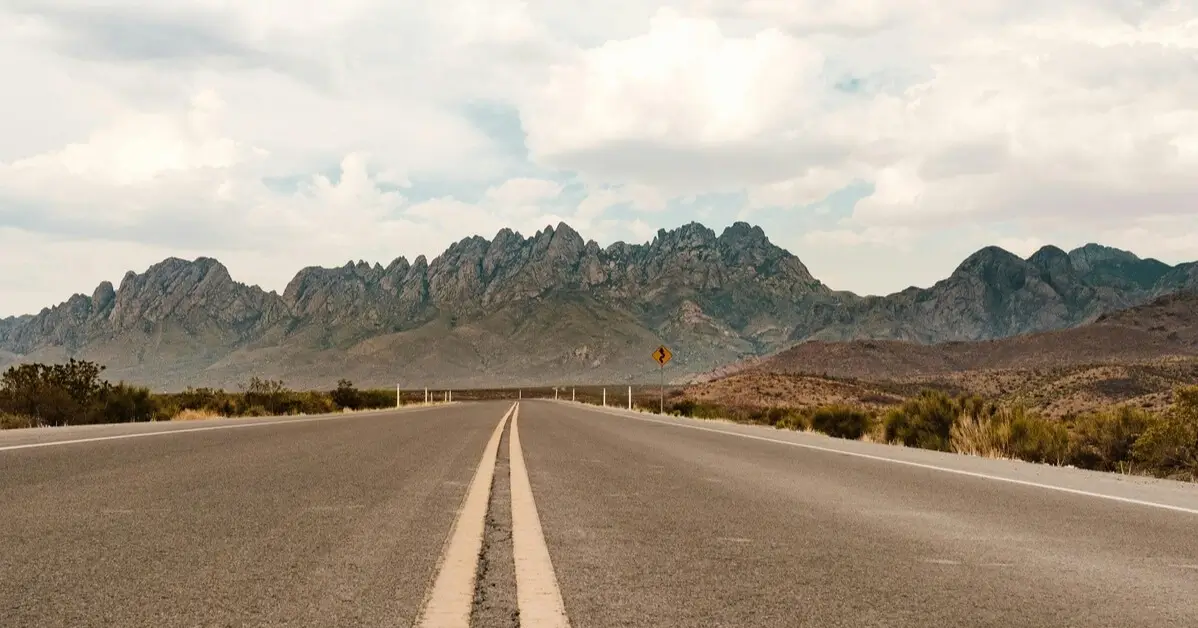 Open road leading toward the Organ Mountains in New Mexico