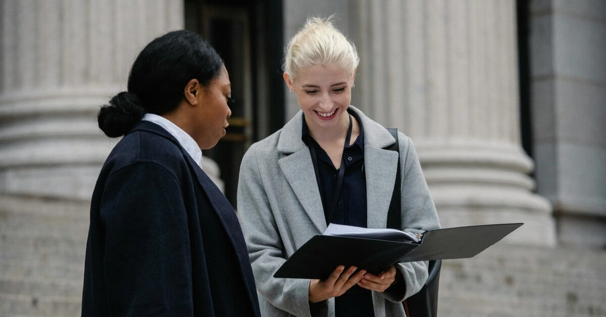 Two DUI lawyers discussing legal documents outside a courthouse